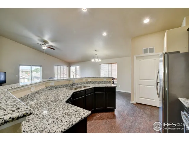 a kitchen with a refrigerator and a sink