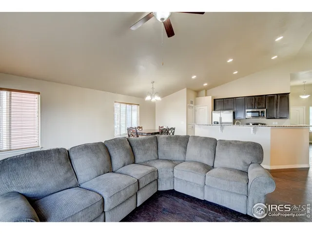 a living room with furniture and kitchen view