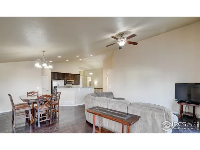 a living room with furniture and a ceiling fan