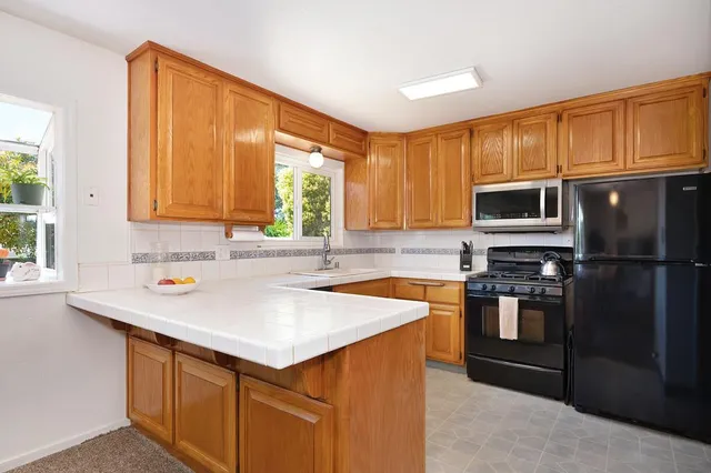 a kitchen with a sink stove and microwave