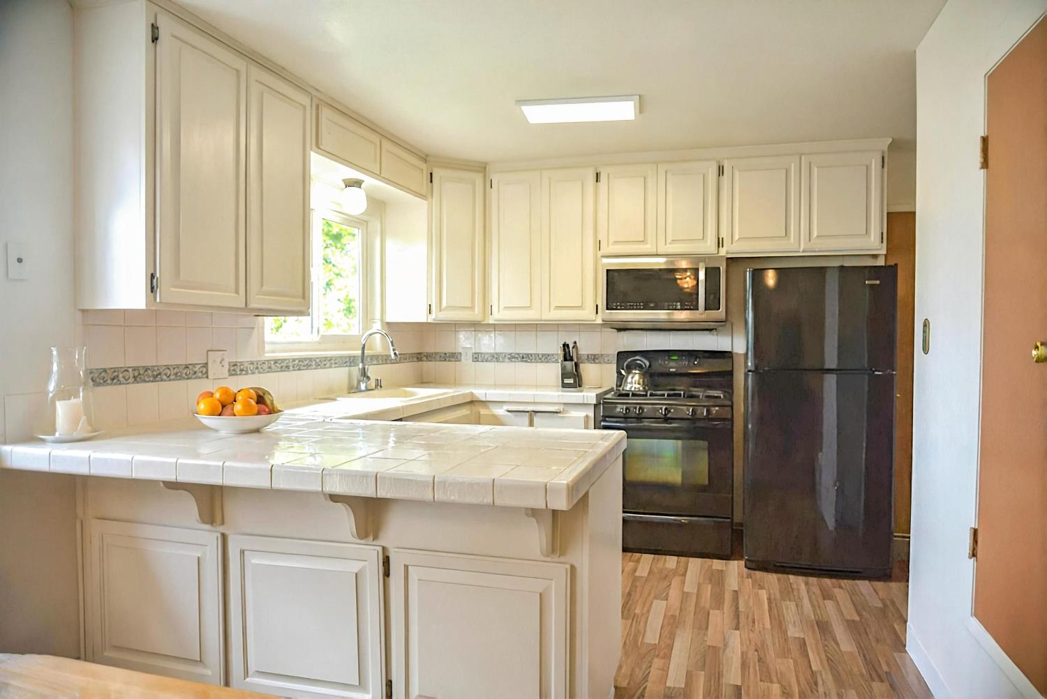 1333 Wesley Lane Auburn, CA 95603 - Photo 12 of 35 a kitchen with a refrigerator a stove a sink and a cabinets