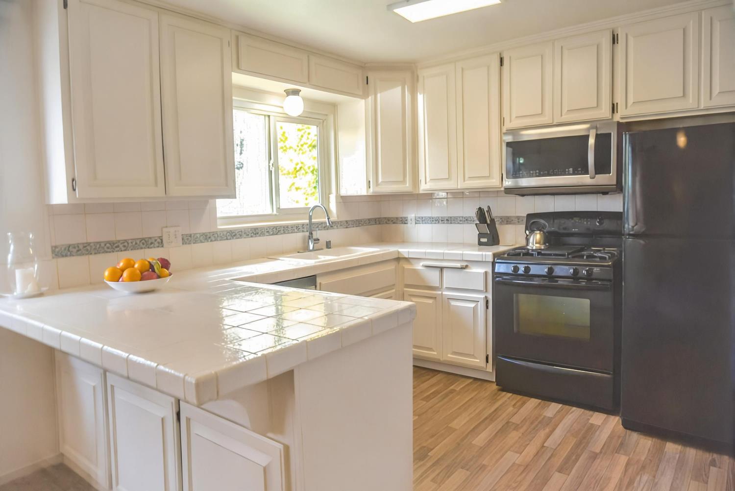 1333 Wesley Lane Auburn, CA 95603 - Photo 13 of 35 a kitchen with granite countertop a sink stainless steel appliances and cabinets