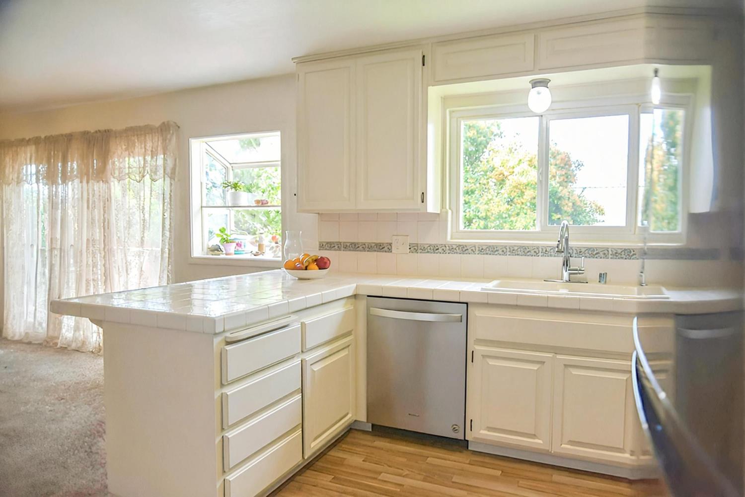 1333 Wesley Lane Auburn, CA 95603 - Photo 14 of 35 a kitchen with a sink window and cabinets