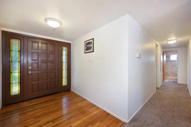 a view of hallway with wooden floor