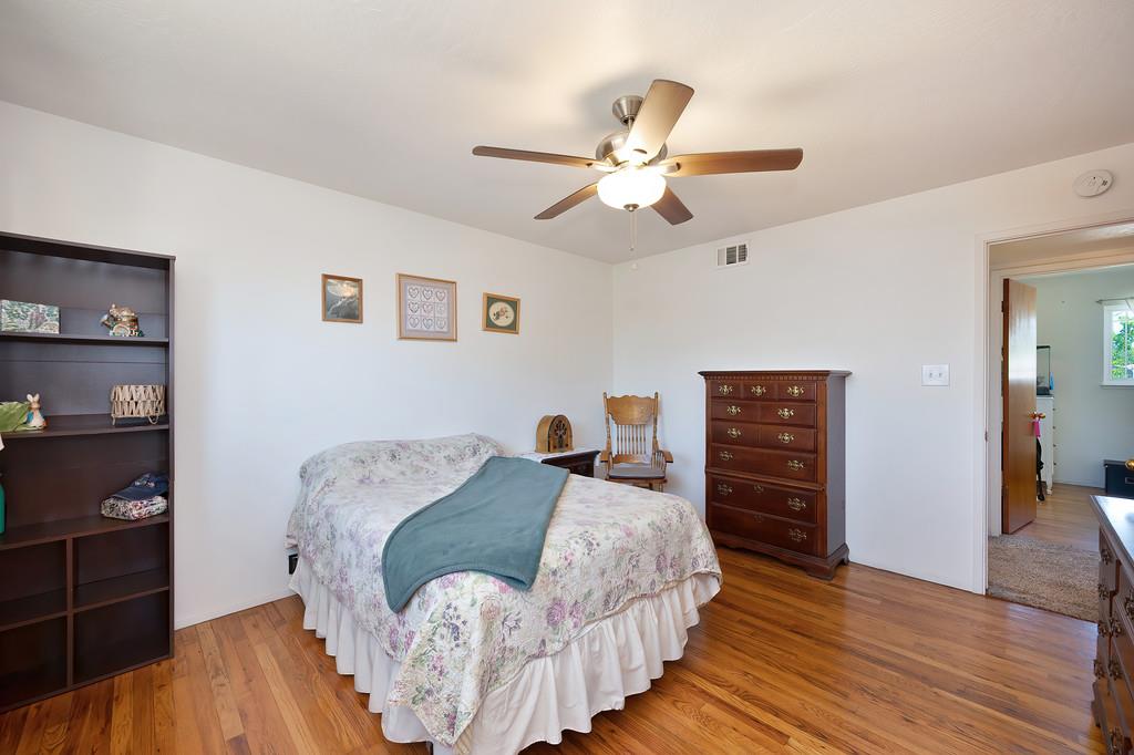 1333 Wesley Lane Auburn, CA 95603 - Photo 20 of 35 a bedroom with a bed and wooden floor