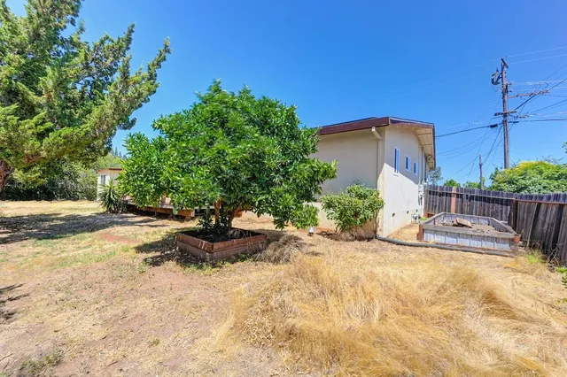 a view of small yard with wooden fence
