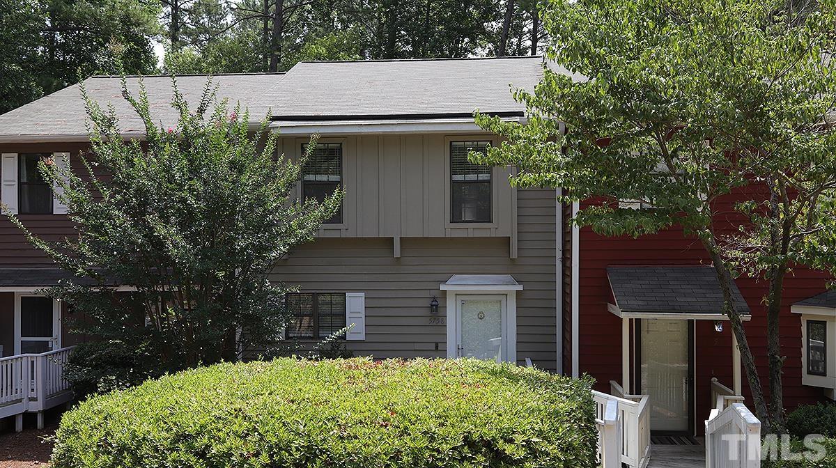 5758 Pool Side Drive Raleigh, NC 27612 - Photo 1 of 24 a brick house with a small yard plants and large tree