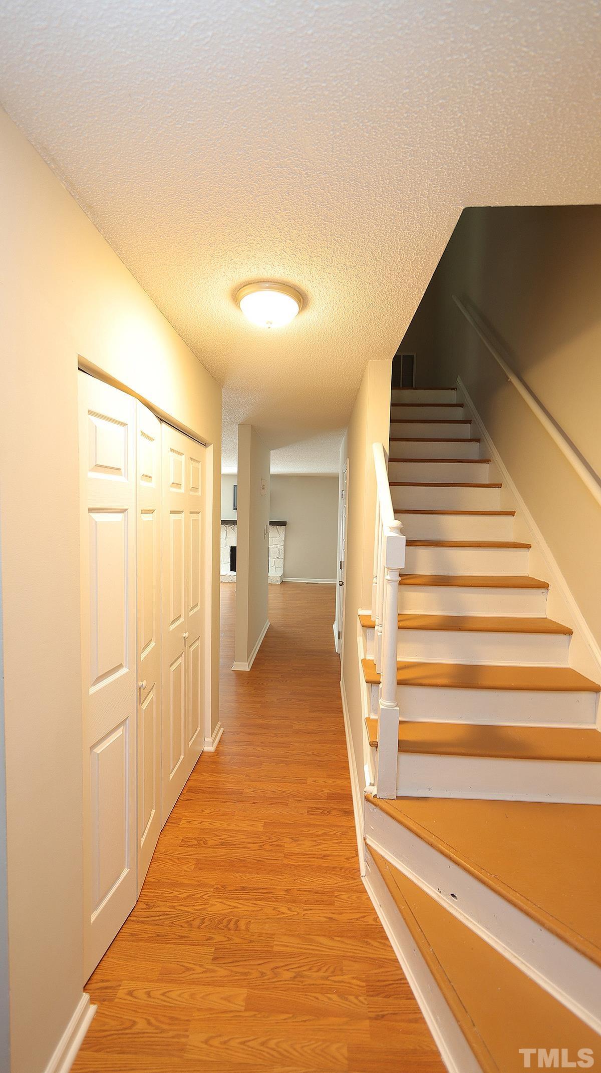 5758 Pool Side Drive Raleigh, NC 27612 - Photo 3 of 24 a view of a hallway with wooden floor and staircase