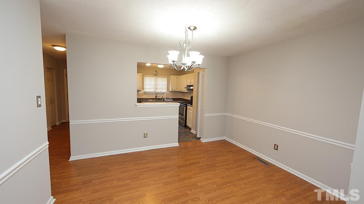 5758 Pool Side Drive Raleigh, NC 27612 - Photo 7 of 24 wooden floor in an empty room with a window