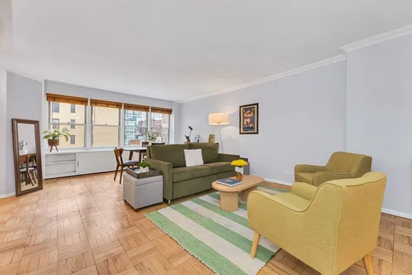 a living room with furniture and a floor to ceiling window
