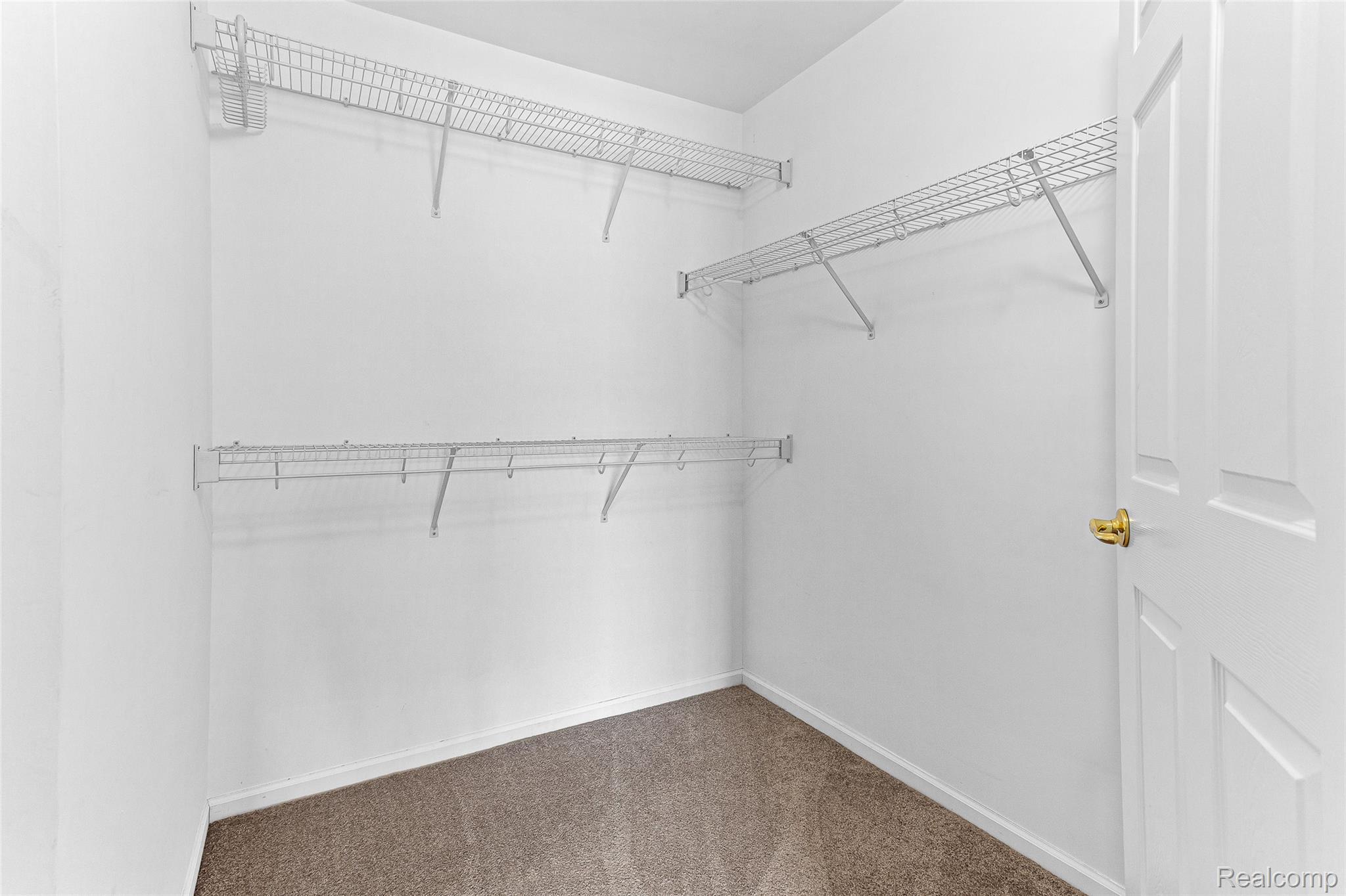 3553 Oakmonte Boulevard Rochester, MI 48306 - Photo 15 of 42 Walk-in closet featuring white walls, wire shelving, and carpet flooring