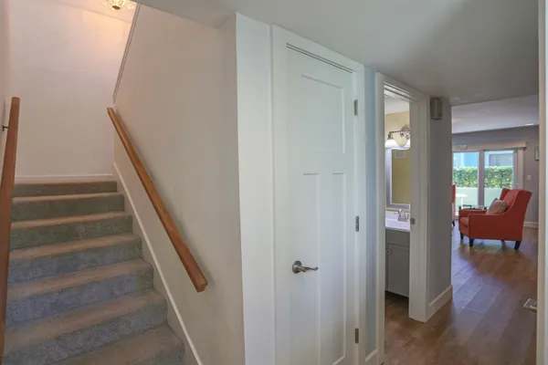 a bedroom with a bed and paintings on the wall
