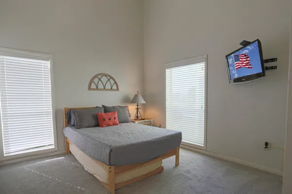 a bedroom with a bed and a chandelier