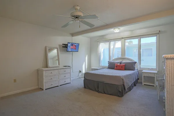 a kitchen with granite countertop a sink cabinets stainless steel appliances and a window