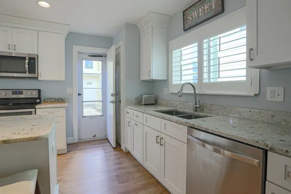 a bedroom with a bed and a large mirror