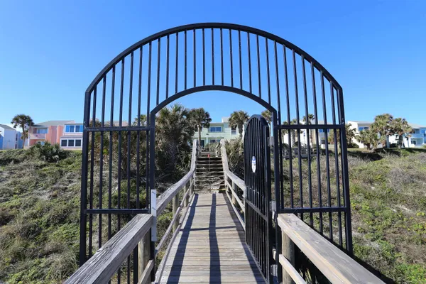 a kitchen with white cabinets a sink and appliances