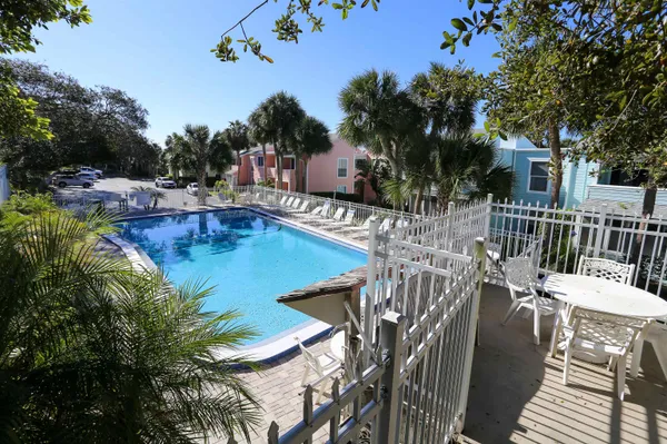 a view of a balcony with wooden floor and fence