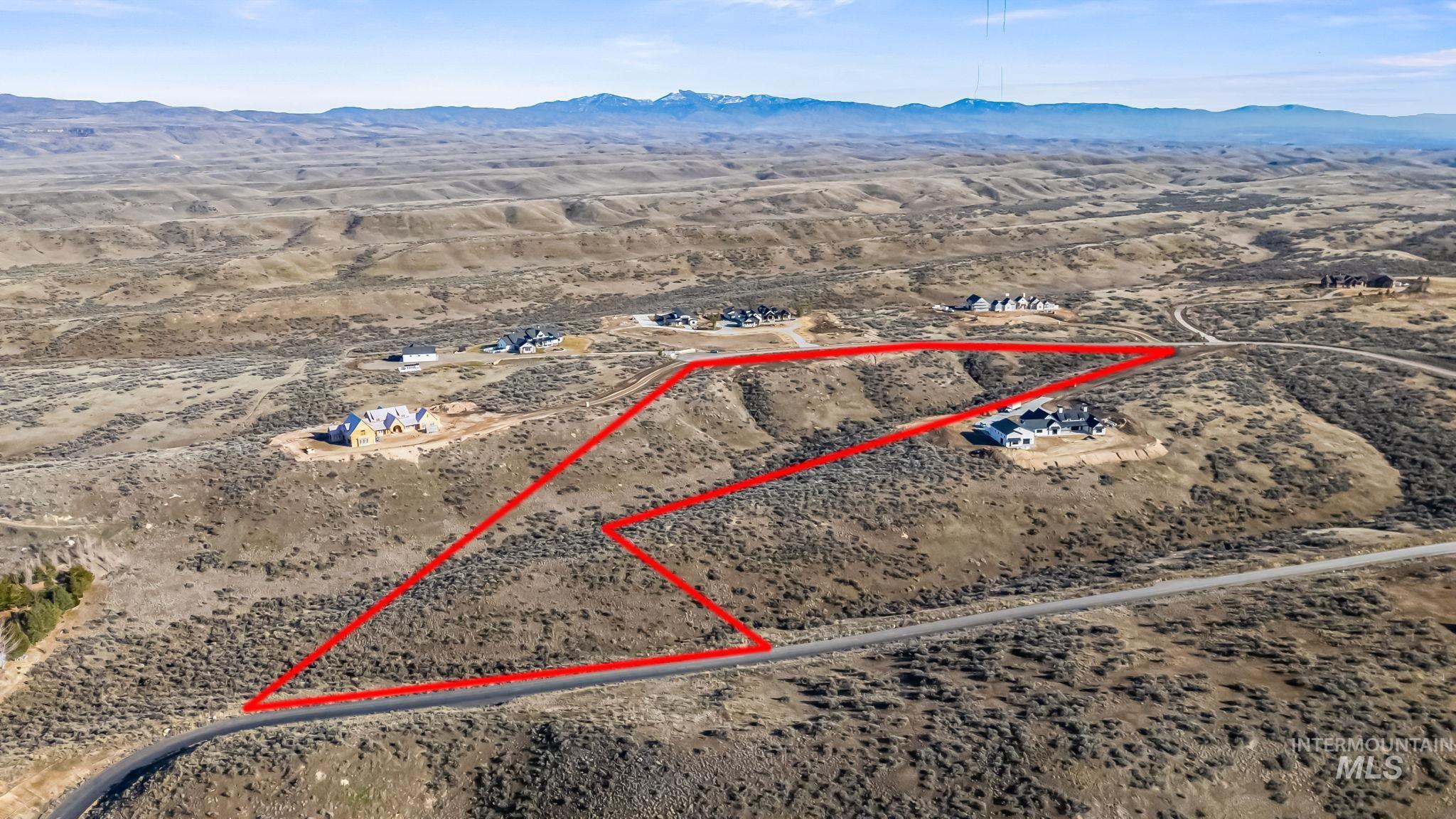9799 North Springer Lane Eagle, ID 83616 - Photo 12 of 15 Aerial view of sparsely populated area featuring property boundaries highlighted and a mountain backdrop