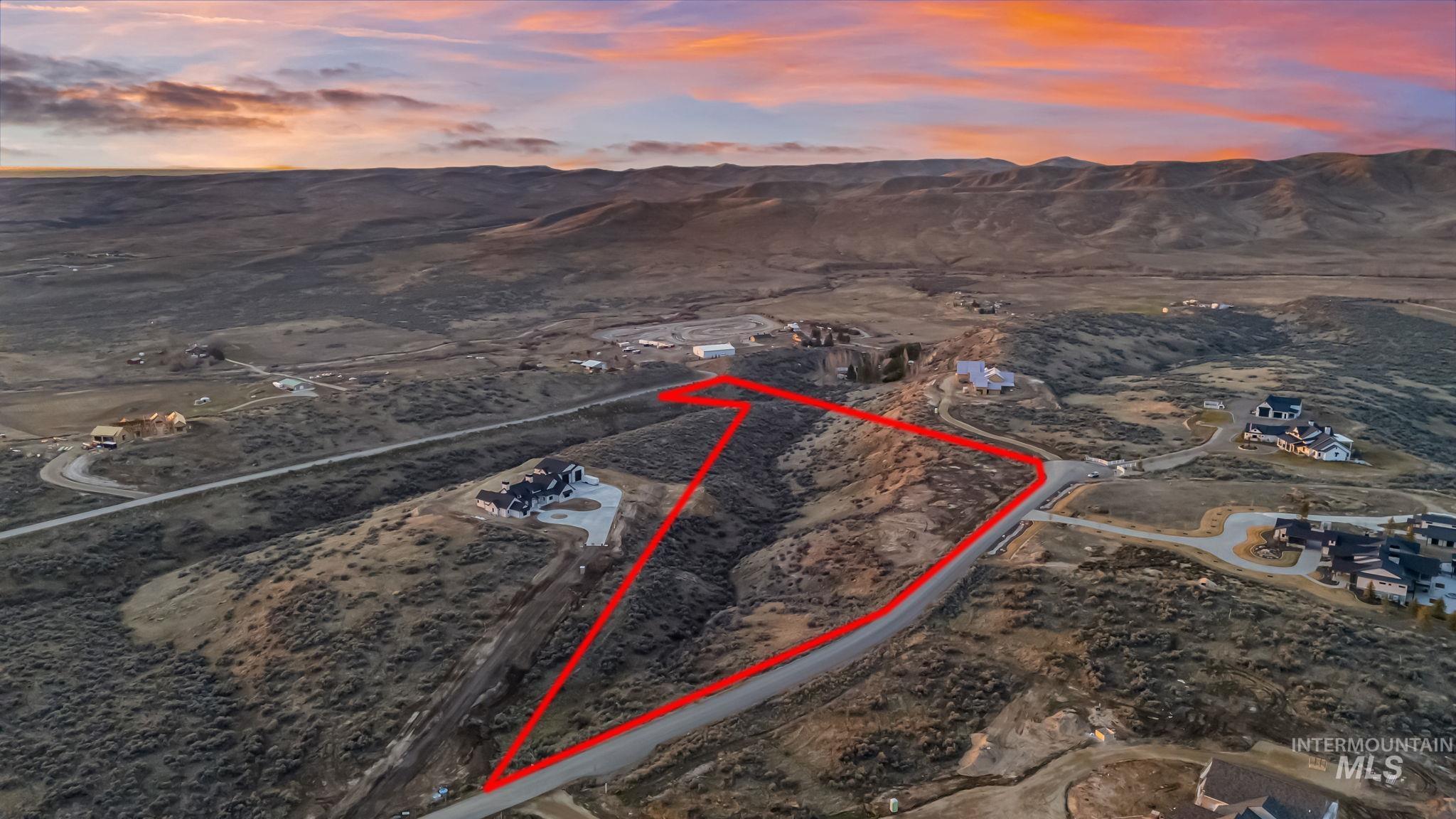 9799 North Springer Lane Eagle, ID 83616 - Photo 4 of 15 Aerial view at dusk of property boundaries highlighted, a mountain view, view of desert, and a view of countryside