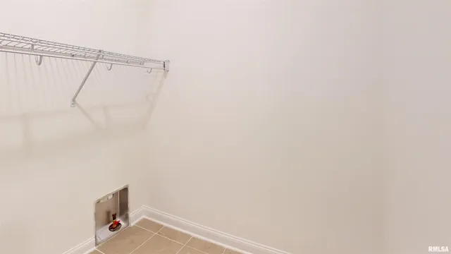 a utility room with a shower curtain and sink