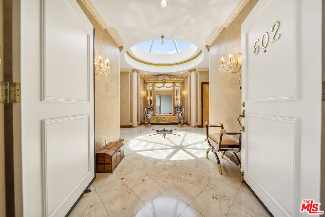 425 North Maple Drive, Unit PH 602 Beverly Hills, CA 90210 - Photo 1 of 37 a view of a hallway with a furniture and a mirror
