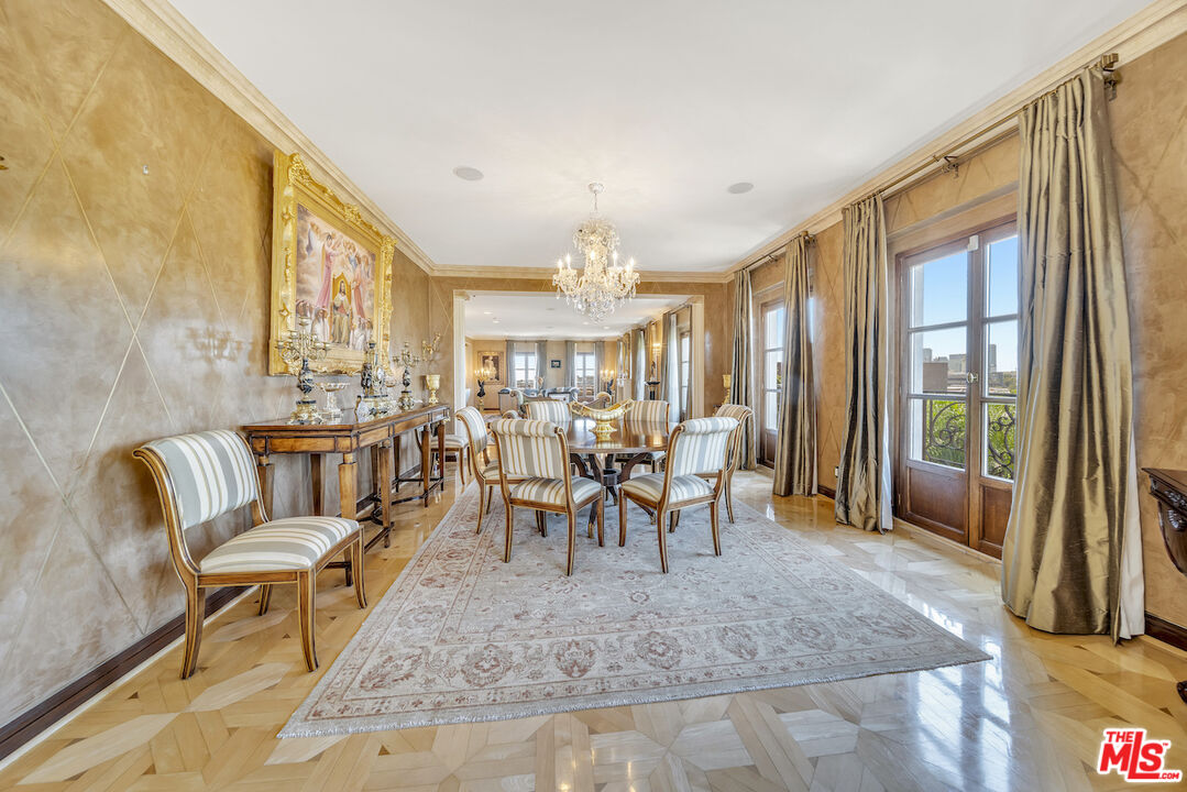 425 North Maple Drive, Unit PH 602 Beverly Hills, CA 90210 - Photo 11 of 37 a dining room with furniture a chandelier and glass door