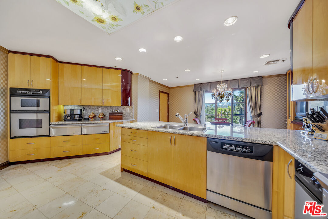 425 North Maple Drive, Unit PH 602 Beverly Hills, CA 90210 - Photo 13 of 37 a kitchen with stainless steel appliances granite countertop a sink and cabinets