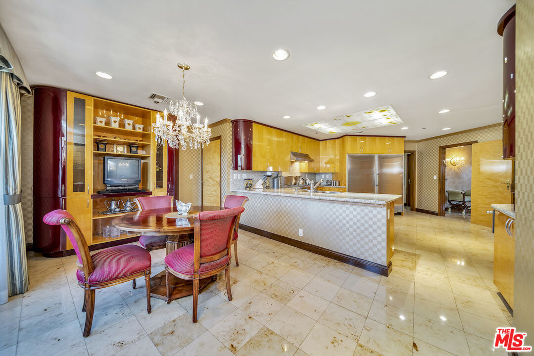 425 North Maple Drive, Unit PH 602 Beverly Hills, CA 90210 - Photo 14 of 37 a living room with stainless steel appliances kitchen island granite countertop furniture and a flat screen tv