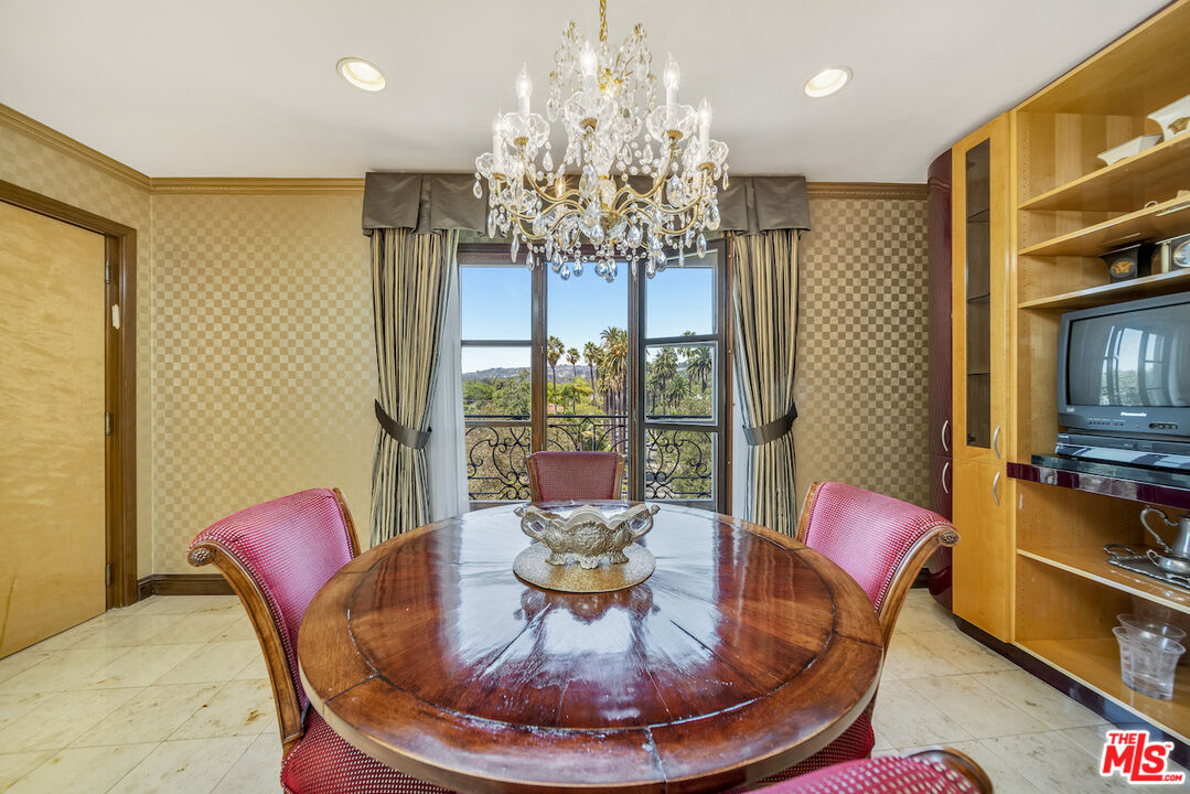 425 North Maple Drive, Unit PH 602 Beverly Hills, CA 90210 - Photo 15 of 37 a dining room with furniture a chandelier and window
