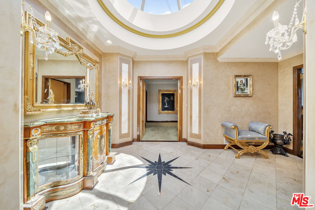 425 North Maple Drive, Unit PH 602 Beverly Hills, CA 90210 - Photo 22 of 37 a living room with furniture a fireplace and a chandelier