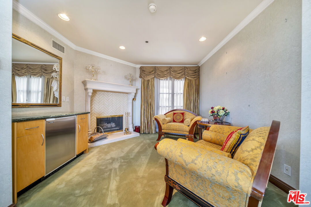 425 North Maple Drive, Unit PH 602 Beverly Hills, CA 90210 - Photo 24 of 37 a living room with furniture and a fireplace