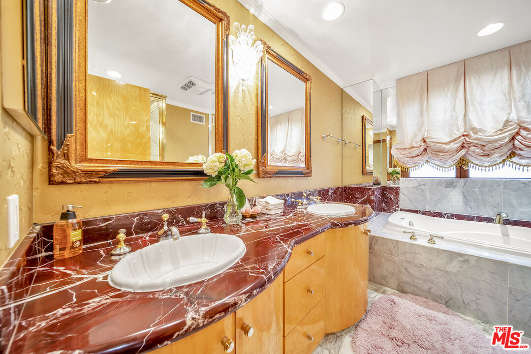 425 North Maple Drive, Unit PH 602 Beverly Hills, CA 90210 - Photo 27 of 37 a bathroom with a sink double vanity and a mirror