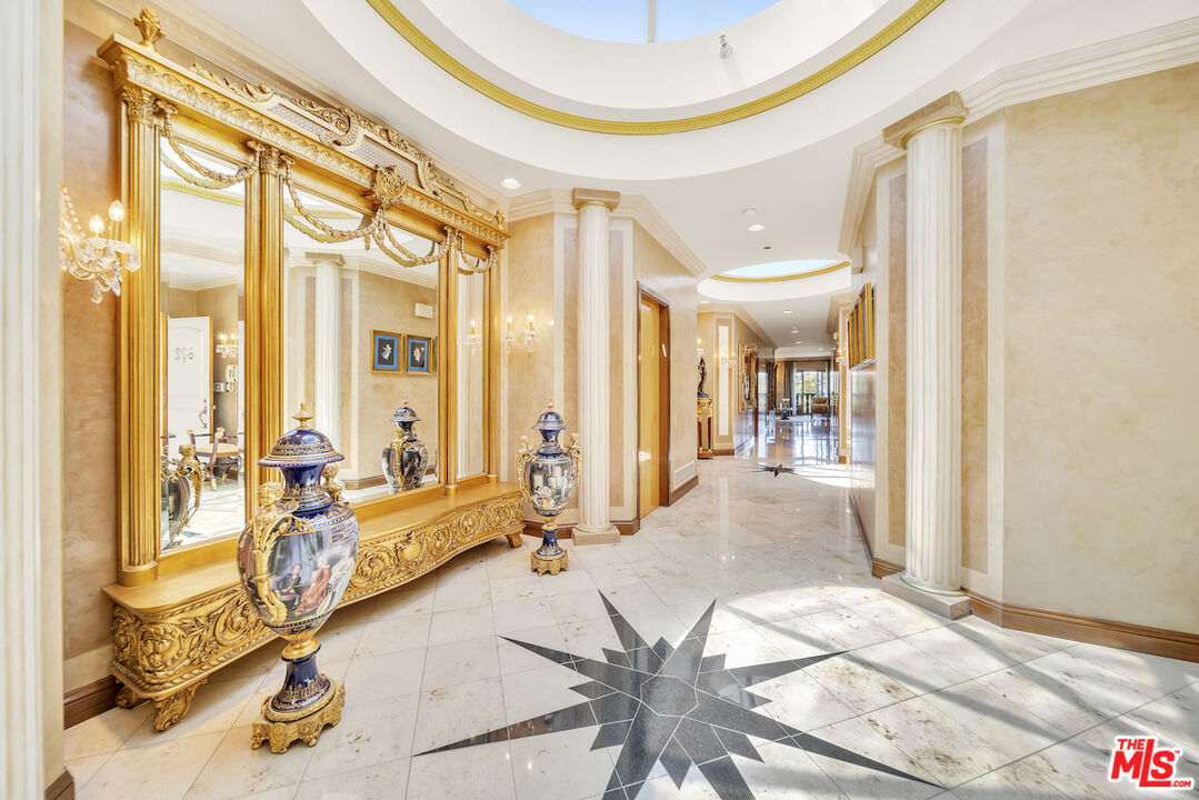 425 North Maple Drive, Unit PH 602 Beverly Hills, CA 90210 - Photo 3 of 37 a lobby with furniture and floor to ceiling windows