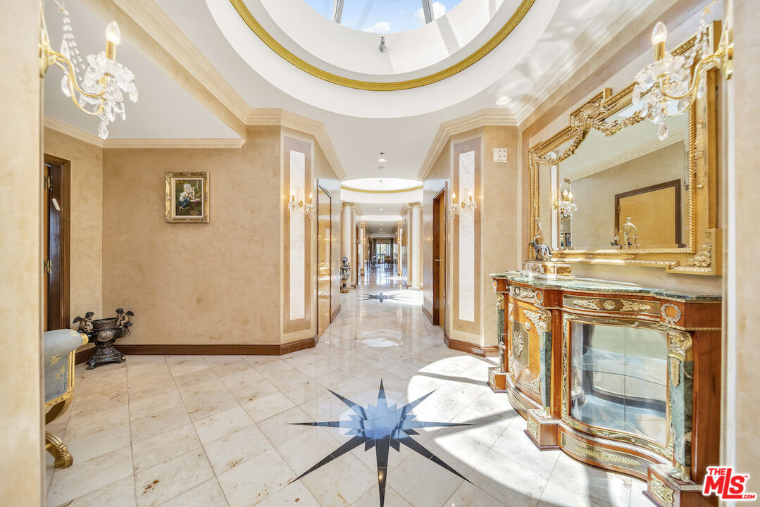 425 North Maple Drive, Unit PH 602 Beverly Hills, CA 90210 - Photo 31 of 37 a view of a hallway with furniture and a chandelier