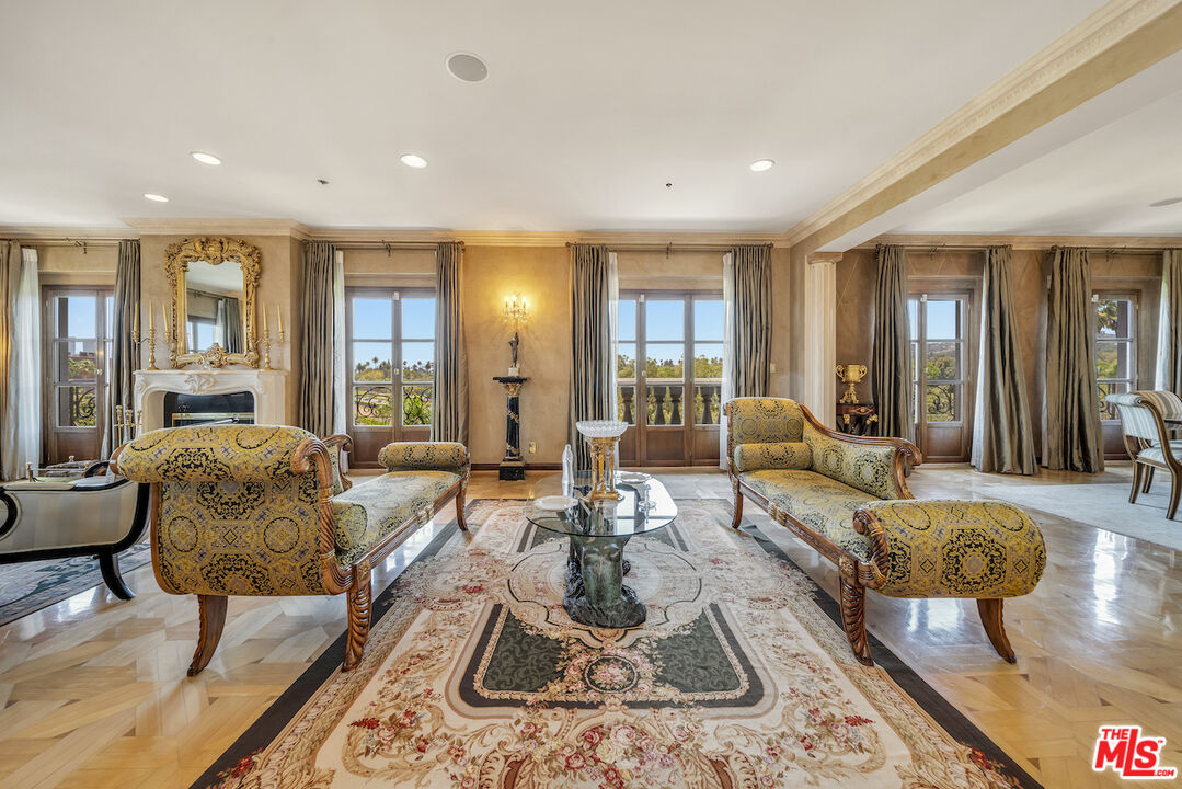 425 North Maple Drive, Unit PH 602 Beverly Hills, CA 90210 - Photo 4 of 37 a living room with furniture or couch and a large window