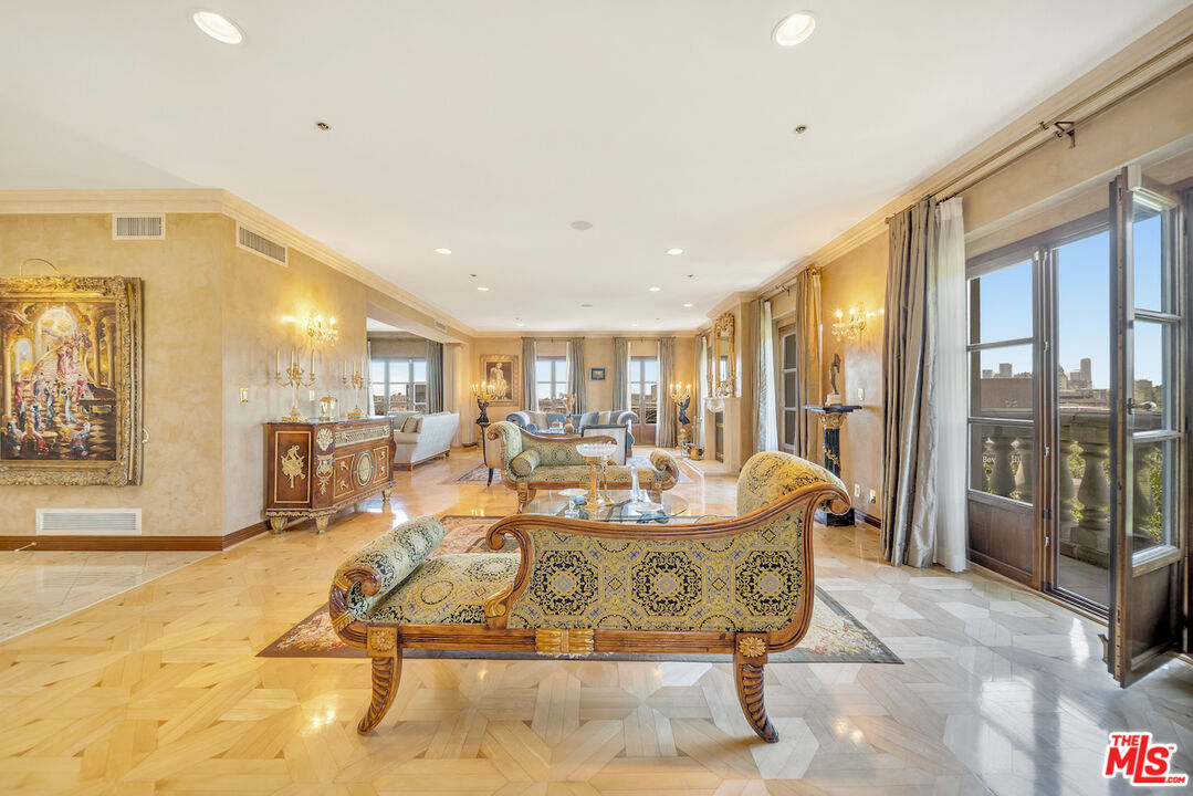 425 North Maple Drive, Unit PH 602 Beverly Hills, CA 90210 - Photo 5 of 37 a dining hall with couches a dining table and chairs with outer view