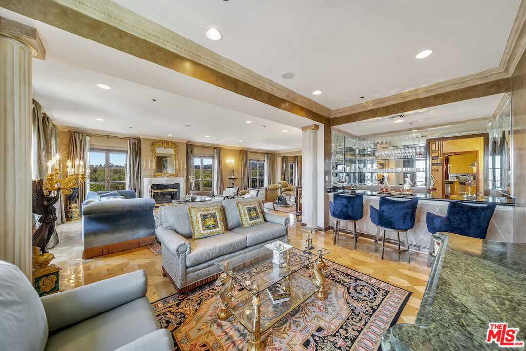 425 North Maple Drive, Unit PH 602 Beverly Hills, CA 90210 - Photo 8 of 37 a living room with furniture wooden floor and a large window