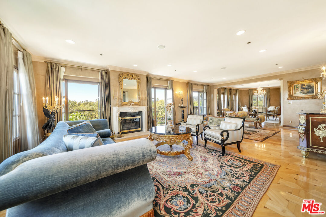 425 North Maple Drive, Unit PH 602 Beverly Hills, CA 90210 - Photo 9 of 37 a living room with furniture and a large window