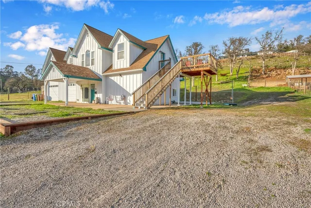 a view of an house with backyard and trees