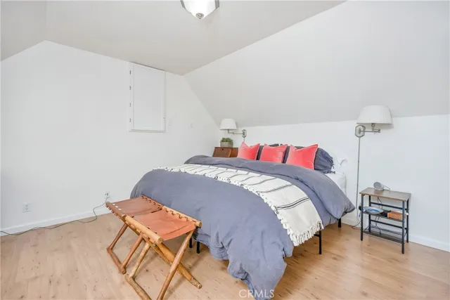 a bedroom with a bed and a chair