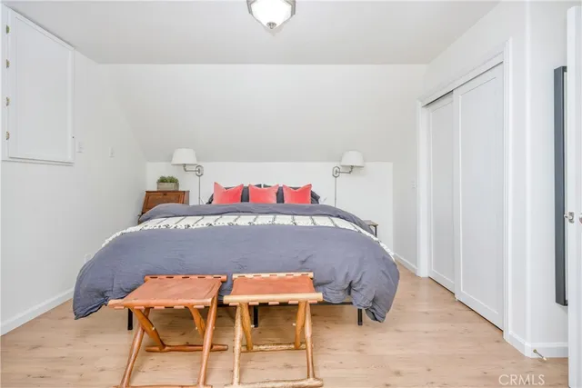 a bedroom with a bed and chair