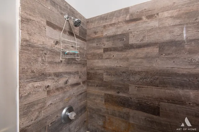 a bedroom with a bed mirror and window