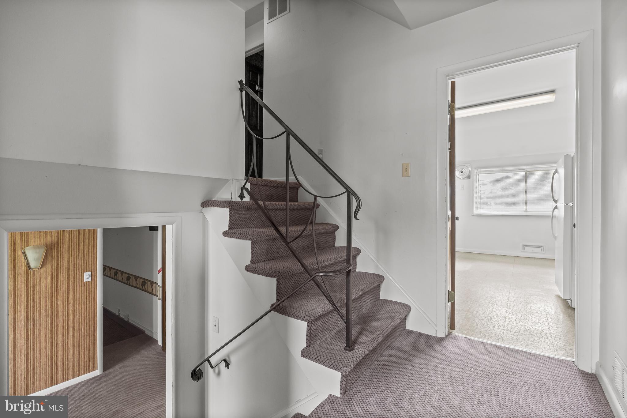 64 Warwick Road Stratford, NJ 08084 - Photo 11 of 28 a view of entryway with a window and stairs