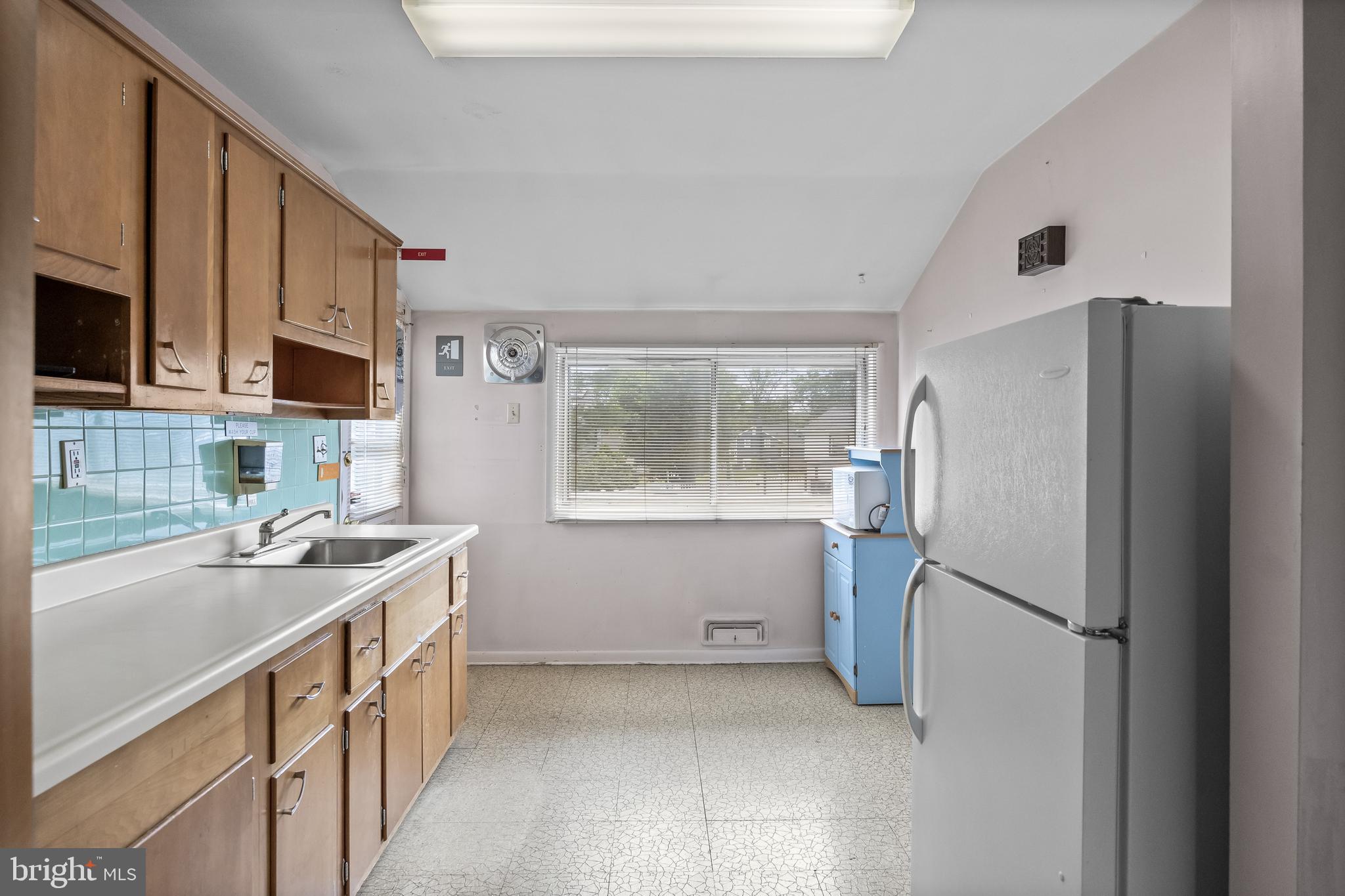 64 Warwick Road Stratford, NJ 08084 - Photo 16 of 28 a kitchen with stainless steel appliances granite countertop a refrigerator a sink a stove a microwave and island