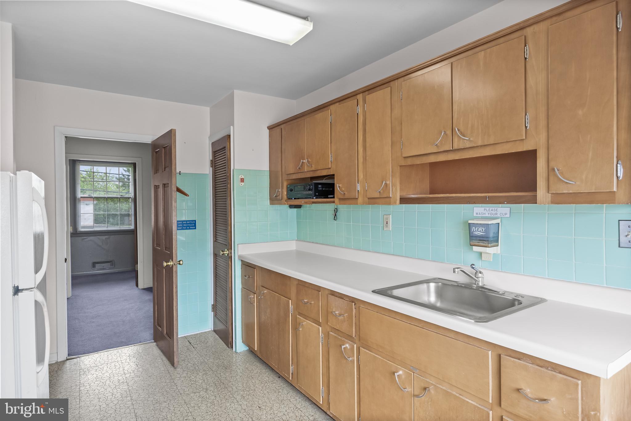 64 Warwick Road Stratford, NJ 08084 - Photo 17 of 28 a kitchen with stainless steel appliances granite countertop a sink a stove and refrigerator