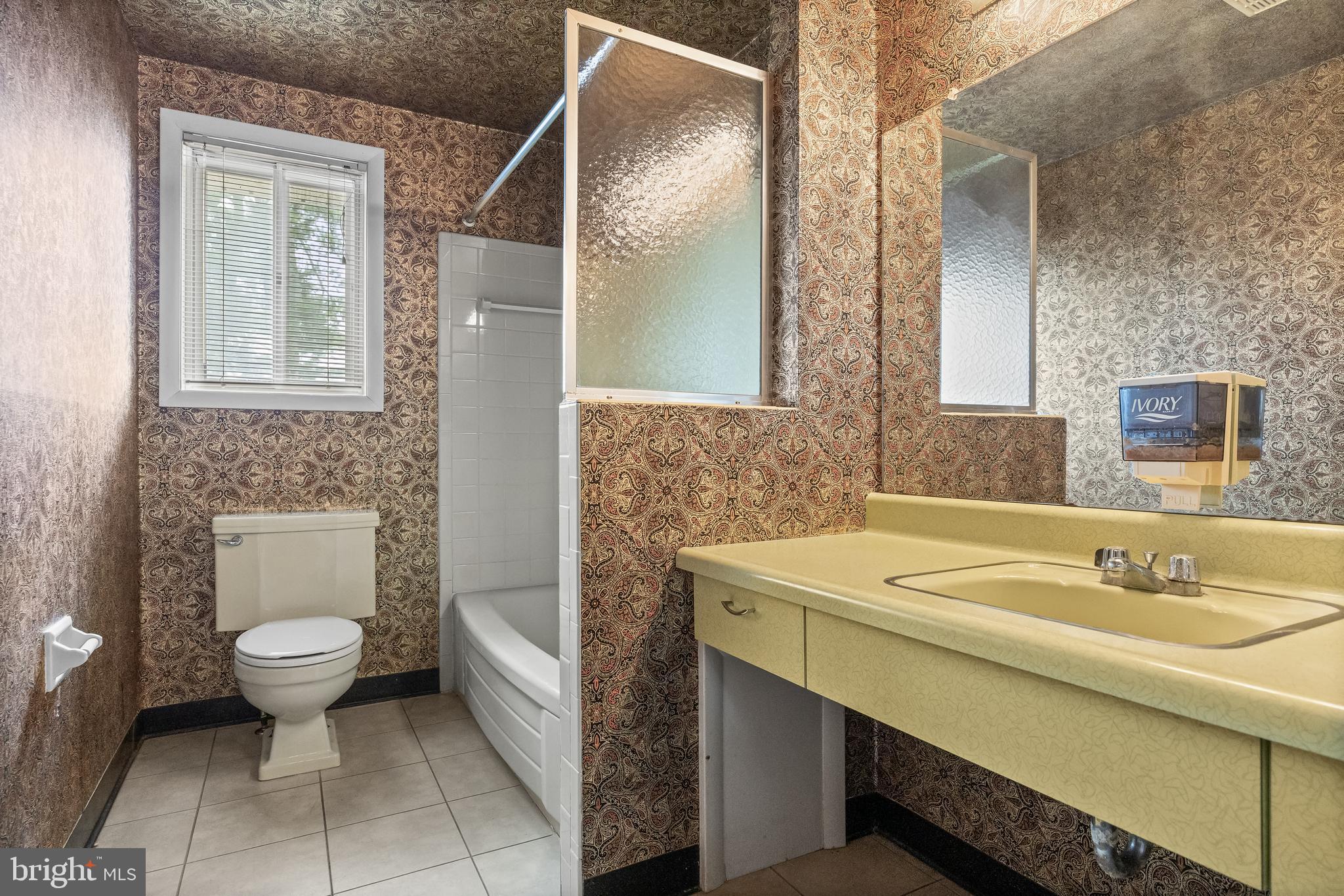 64 Warwick Road Stratford, NJ 08084 - Photo 19 of 28 a bathroom with a sink toilet and mirror