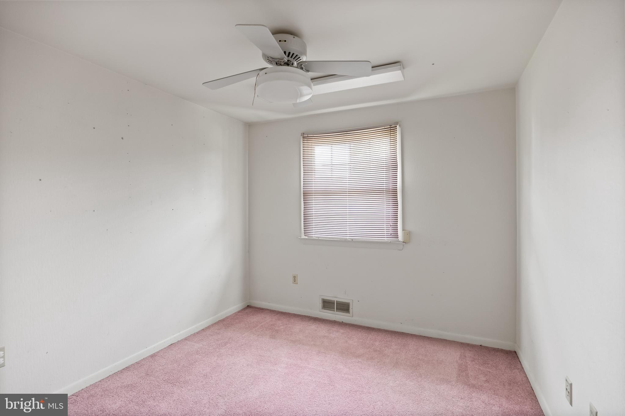 64 Warwick Road Stratford, NJ 08084 - Photo 23 of 28 an empty room with a ceiling fan and window