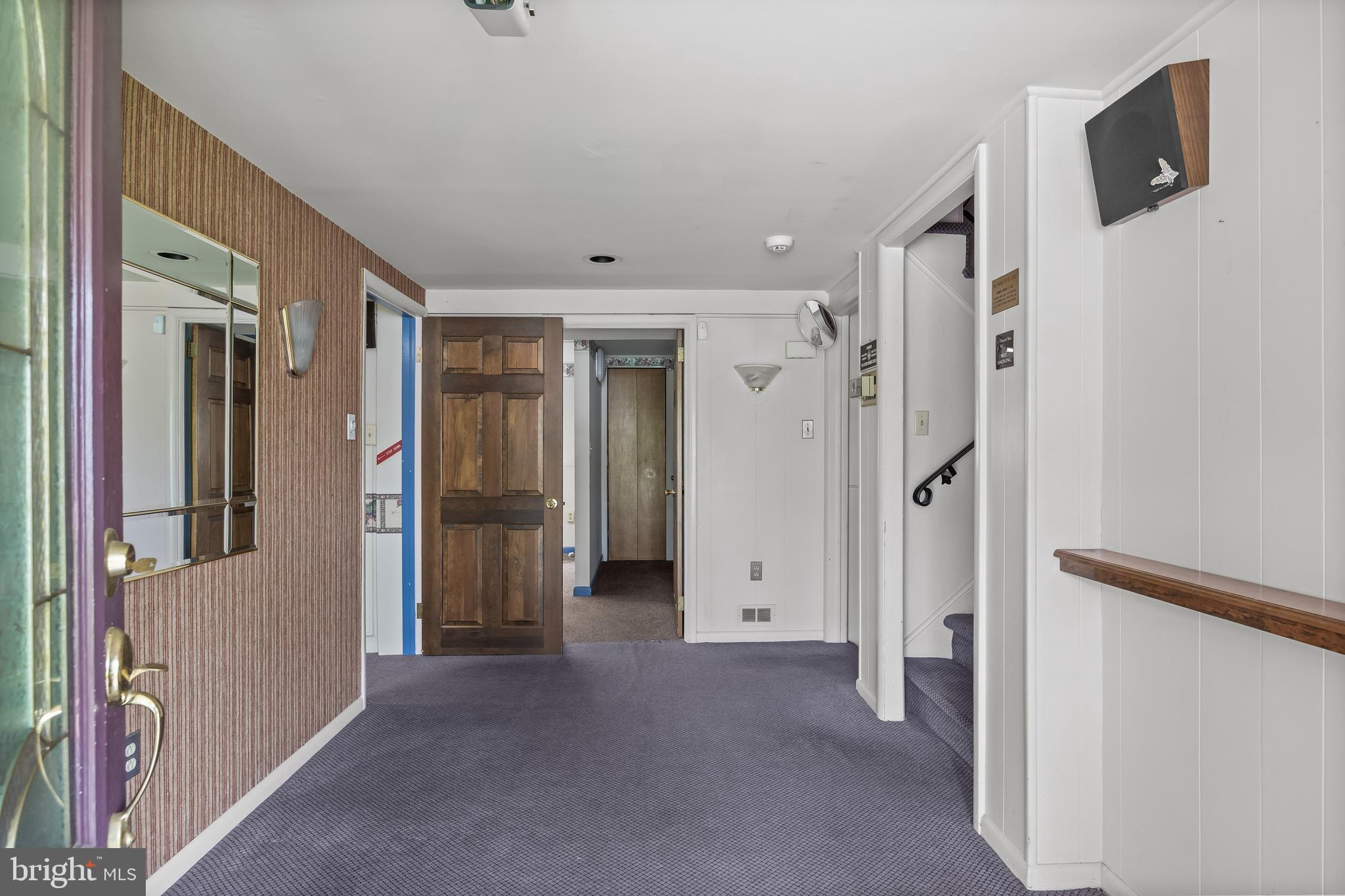 64 Warwick Road Stratford, NJ 08084 - Photo 5 of 28 a view of a hallway with wooden shelves