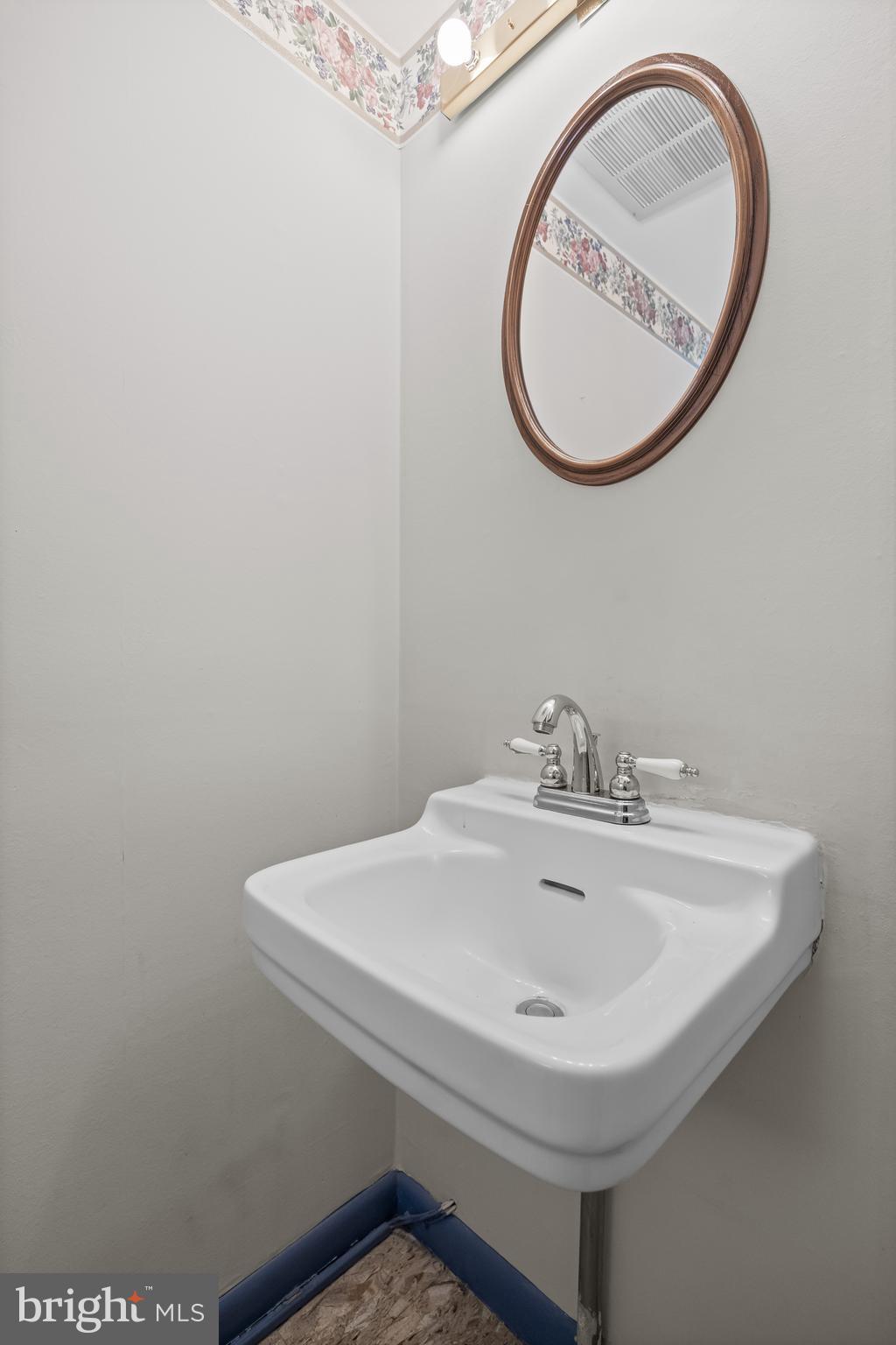 64 Warwick Road Stratford, NJ 08084 - Photo 10 of 28 a bathroom with a sink and a mirror