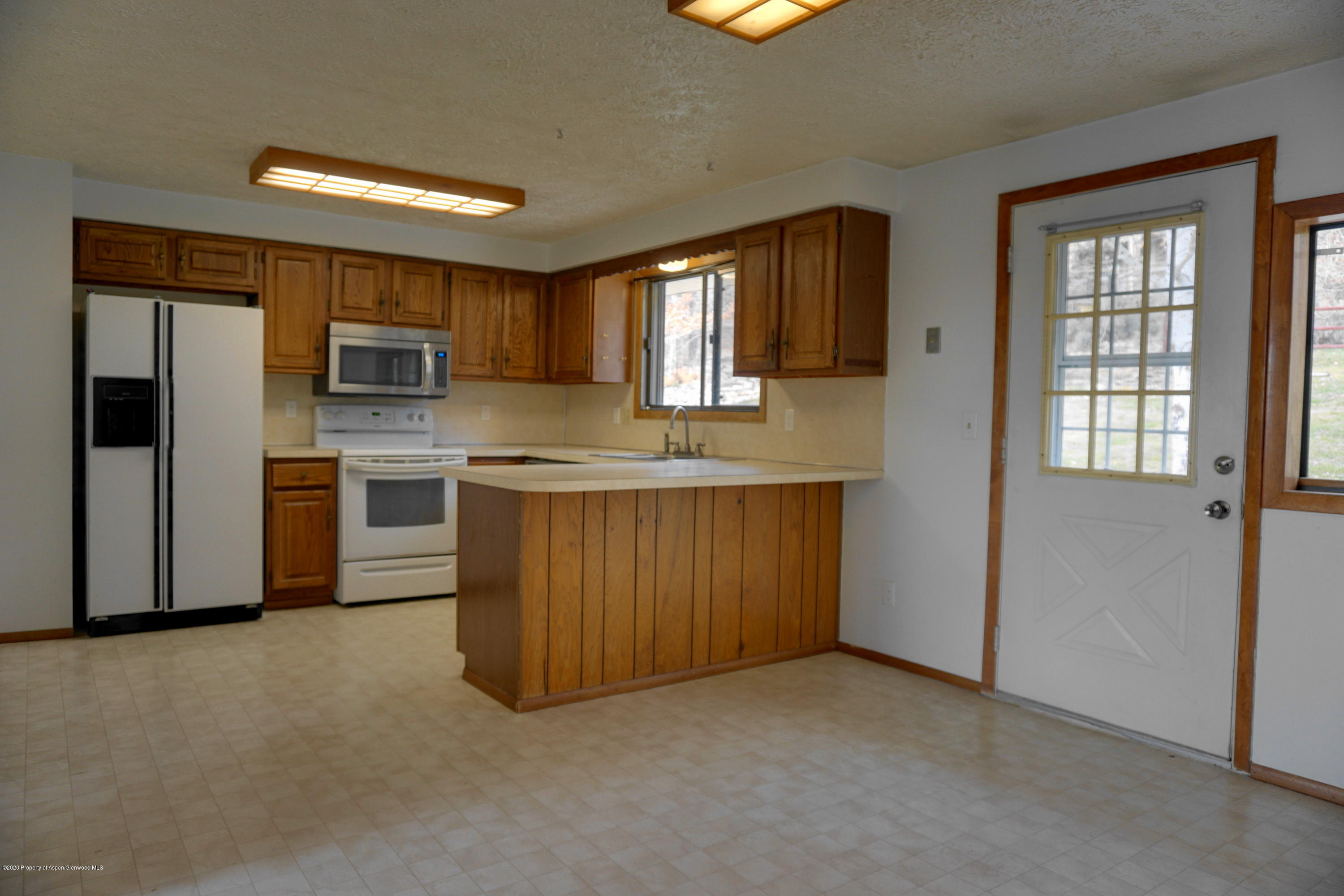 1409 Silver Sage Road Meeker, CO 81641 - Photo 6 of 26 a kitchen with kitchen island a sink stainless steel appliances and window